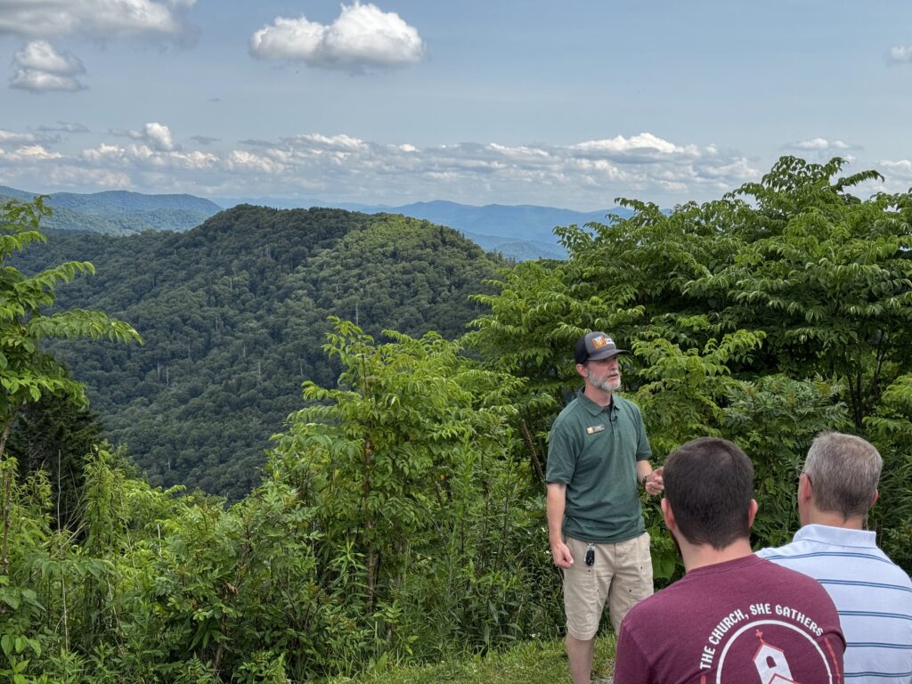 Luke Wayne Teaching Small Group at Forested Mountain Overlook Luke Wayne of Canyon Ministries teaching guests at a forested mountain overlook in Great Smoky Mountains National Park