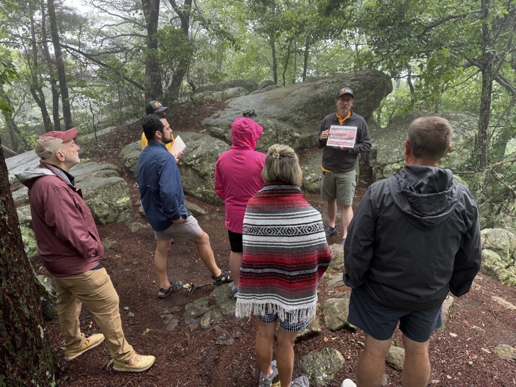 Luke Wayne and Adam Huff of Canyon Ministries teaching guests with geology visuals among large boulders in Great Smoky Mountains National Park