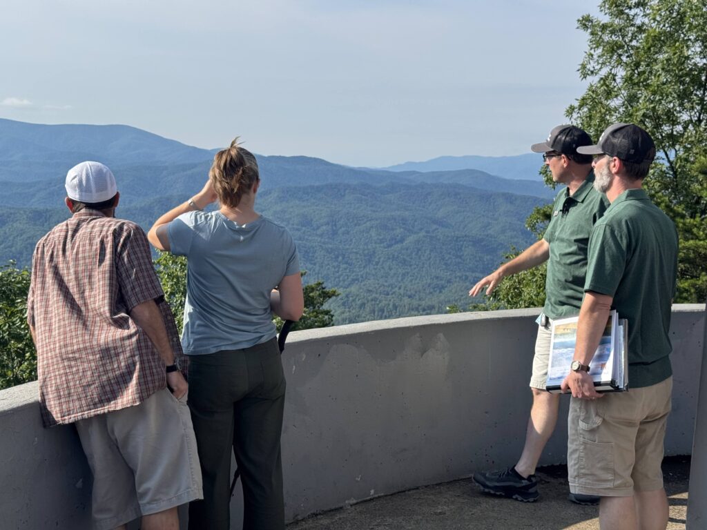 Adam Huff and Luke Wayne of Canyon Ministries teaching guests from an overlook above layered forested ridges in Great Smoky Mountains National Park