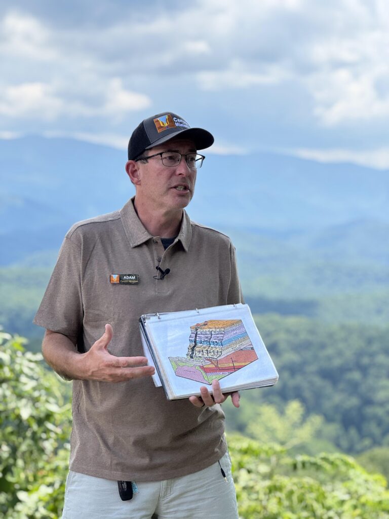 Adam Huff Teaching Smoky Mountains Geology with Cross Section Adam Huff of Canyon Ministries holding a colorful geologic cross section at a Great Smoky Mountains National Park overlook